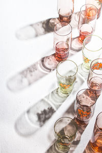 High angle of glasses with back light and beautiful shadows on the white background. copy space