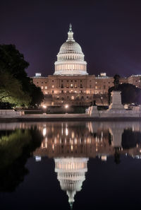 Reflection of building in water at night