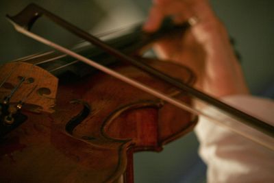 Close-up of man playing guitar