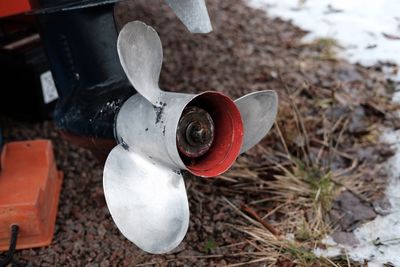 Close-up of rusty object on field