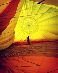Man standing on hot air balloon