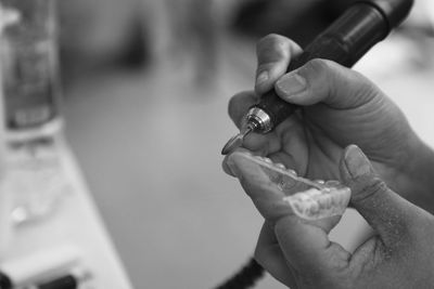 Cropped hands of person making braces