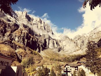 Panoramic shot of buildings and mountains against sky