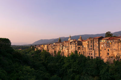 Panoramic view of buildings and mountains against clear sky