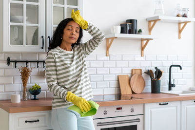 Portrait of woman standing in kitchen