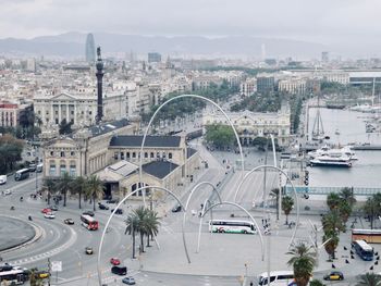 High angle view of vehicles on road along cityscape
