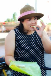 Portrait of smiling woman eating food