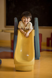 Portrait of happy boy at table