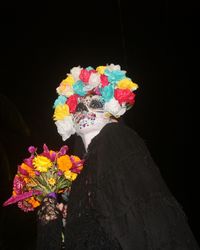 Close-up of multi colored flowers against black background