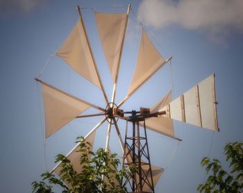 Low angle view of traditional windmill against sky