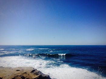 Scenic view of sea against clear blue sky