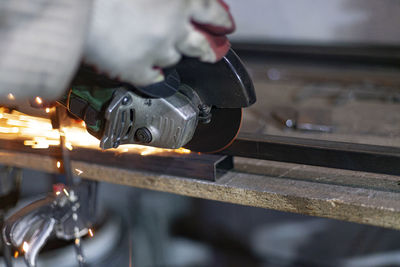 Close-up of man working on metal