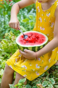 Midsection of woman holding food