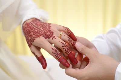 Midsection of couple holding hands