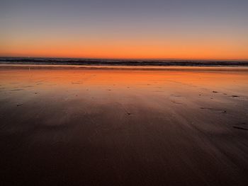 Scenic view of beach against sky during sunset