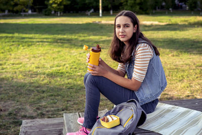 Portrait of young woman using mobile phone