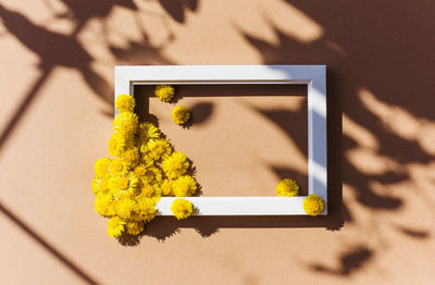 High angle view of human hand holding gift box on table