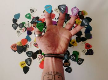 Close-up of hands over colored background