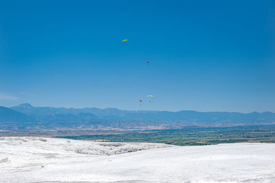 Scenic view of mountains against blue sky