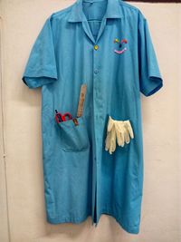 Blue uniform hanging against wall