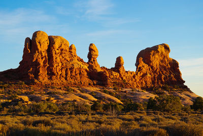 Rock formations on landscape against sky