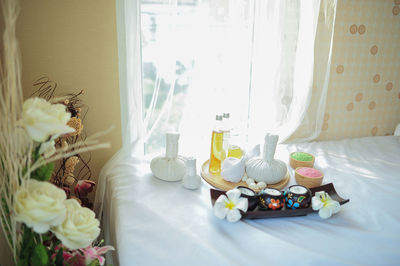 High angle view of spa compress balls and candles on table