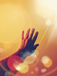 Cropped image of person hand against yellow background
