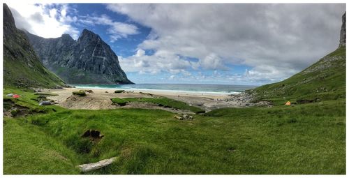 Scenic view of sea and mountains against sky