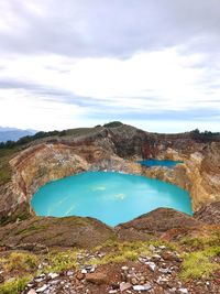 Scenic view of lake kelimutu against sky