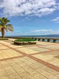 Scenic view of swimming pool by sea against sky