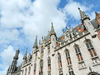Low angle view of temple against cloudy sky