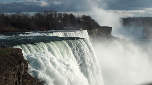 Panoramic view of waterfall against sky