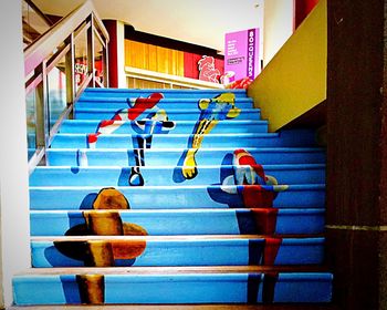 Multi colored steps by swimming pool