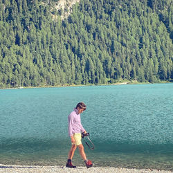 Full length of man walking by lake