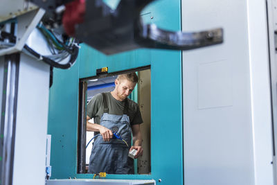 Man working at machine in factory