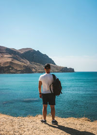 Rear view of man standing on beach