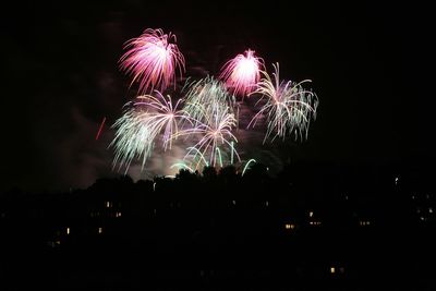 Low angle view of firework display at night