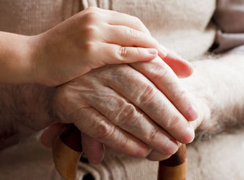 Close-up of hand consoling senior man