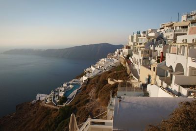 High angle view of townscape by sea against sky