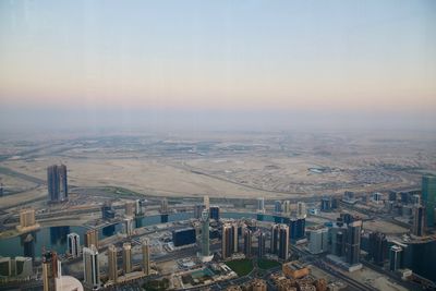 High angle view of buildings against sky during sunset