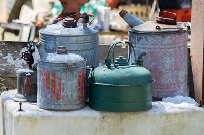 Antique gas cans, or petrol cans are for sale at a outdoor antique sale