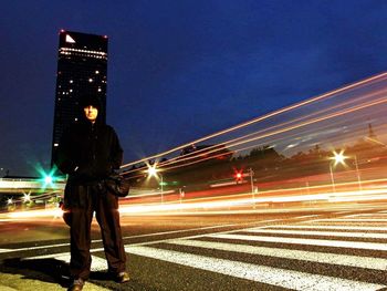 Blurred motion of people walking on road at night