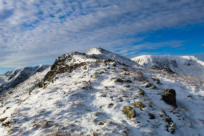 Low angle view of snowcapped mountain against sky