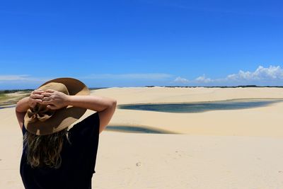 Woman standing on land against sky