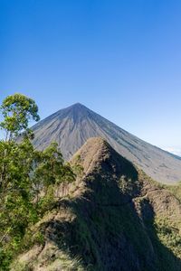 View of volcanic mountain against blue sky