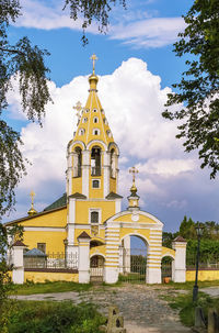 Church by building against sky