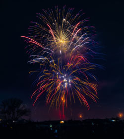 Low angle view of firework display at night