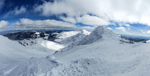 Scenic view of snowcapped mountains against sky
