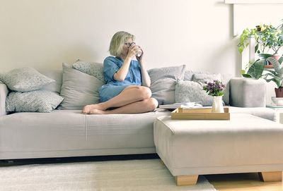 Man sitting on sofa at home