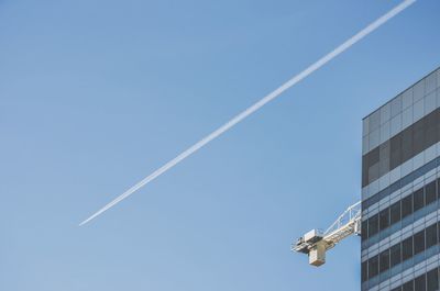 Low angle view of vapor trails in sky